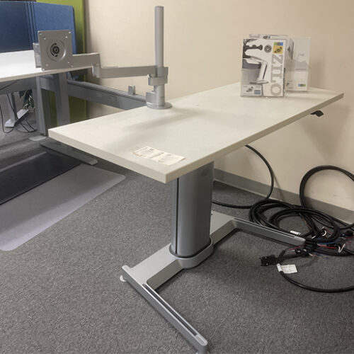 Sit to stand adjustable desk with monitor arm setup