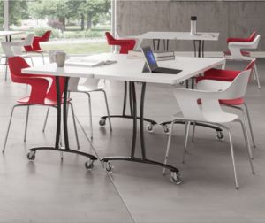 A white breakroom table with red chairs