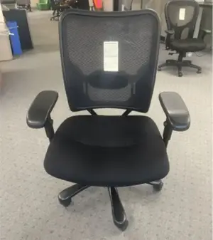 Typical used black office chair with mesh back