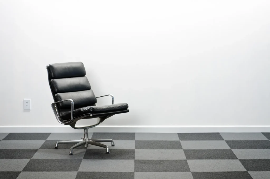 Leather office chair with high back and chrome armrest