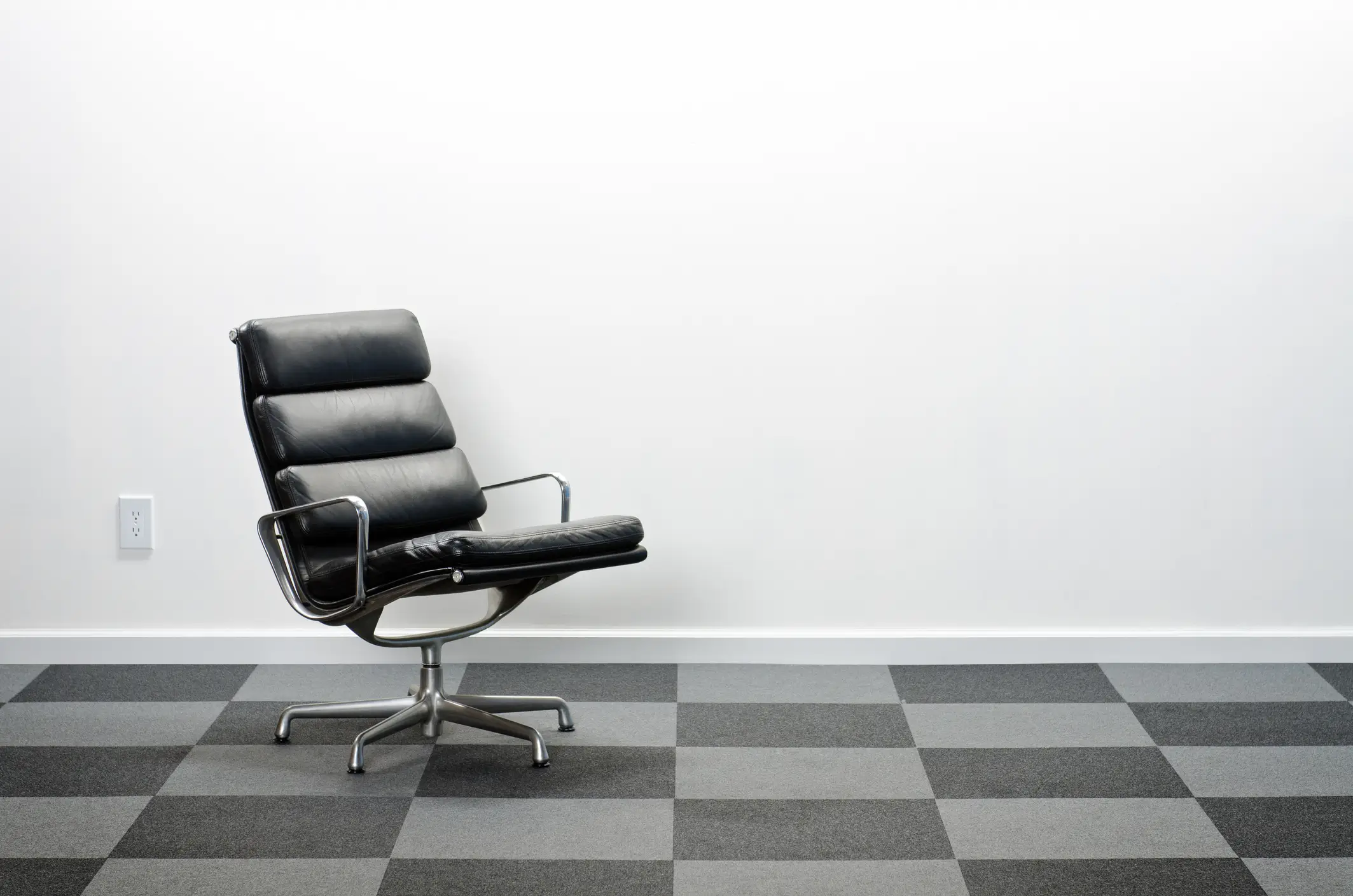 Leather office chair with high back and chrome armrest