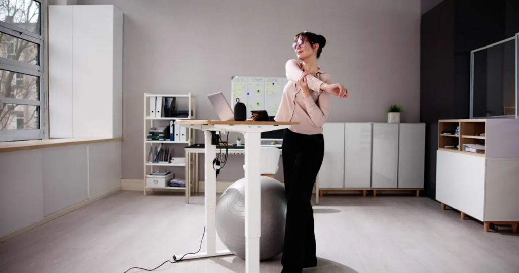 Woman working on a sit-to-stand desk