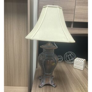 A beige-shaded table lamp displayed at the Office Furniture Expo in Atlanta, GA.