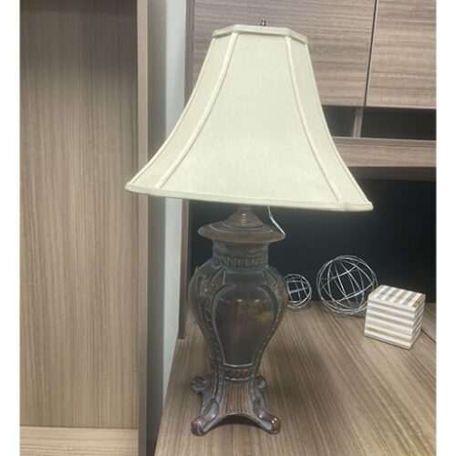 A beige-shaded table lamp displayed at the Office Furniture Expo in Atlanta, GA.